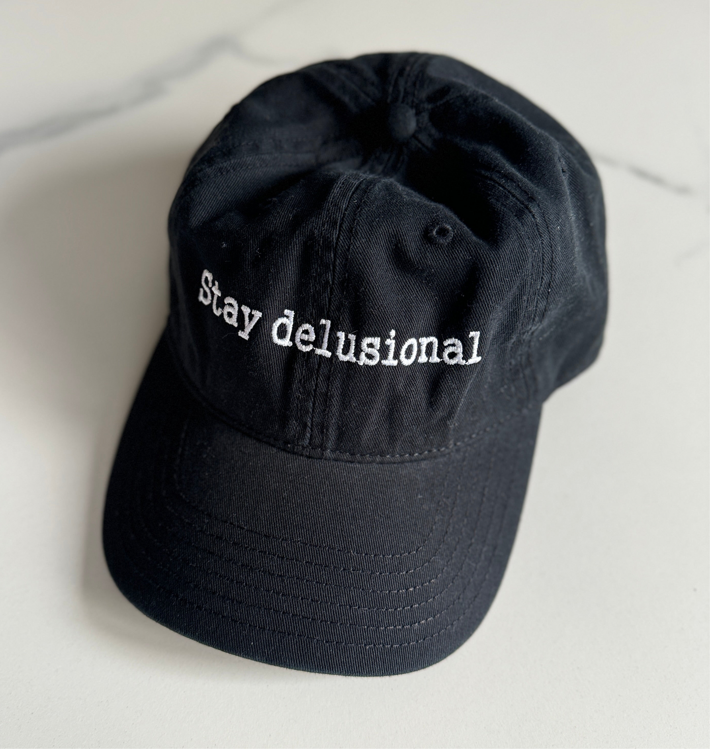 Stay delusional cap