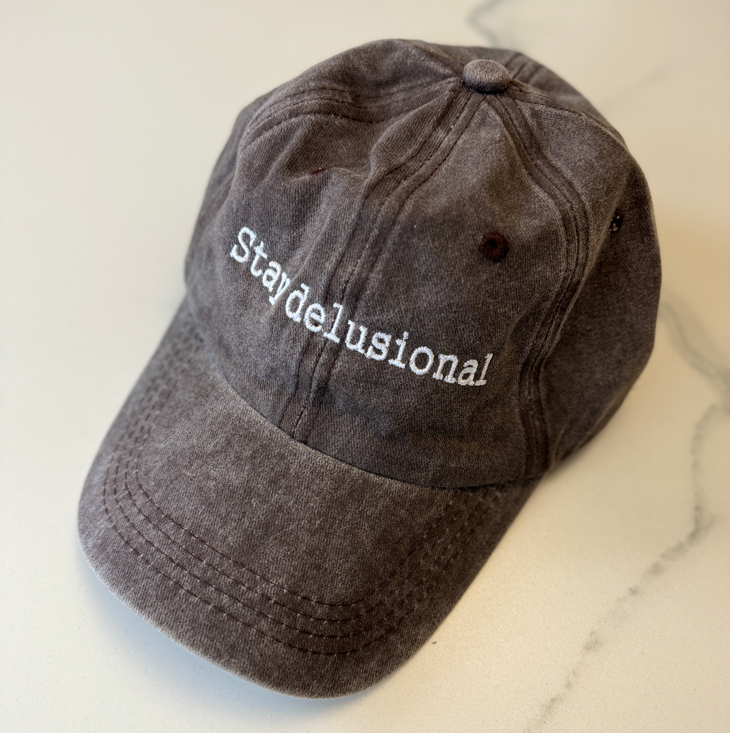 Stay delusional cap