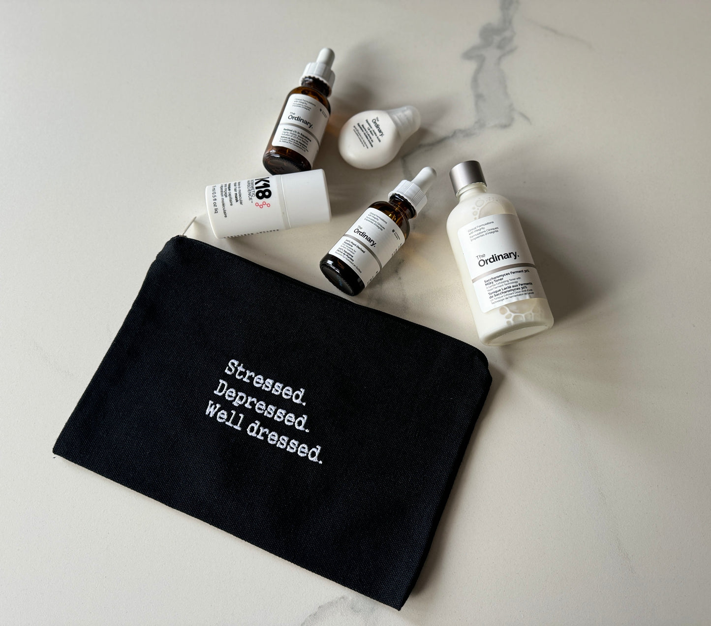 Stressed. Depressed. Well dressed. Cosmetics bag