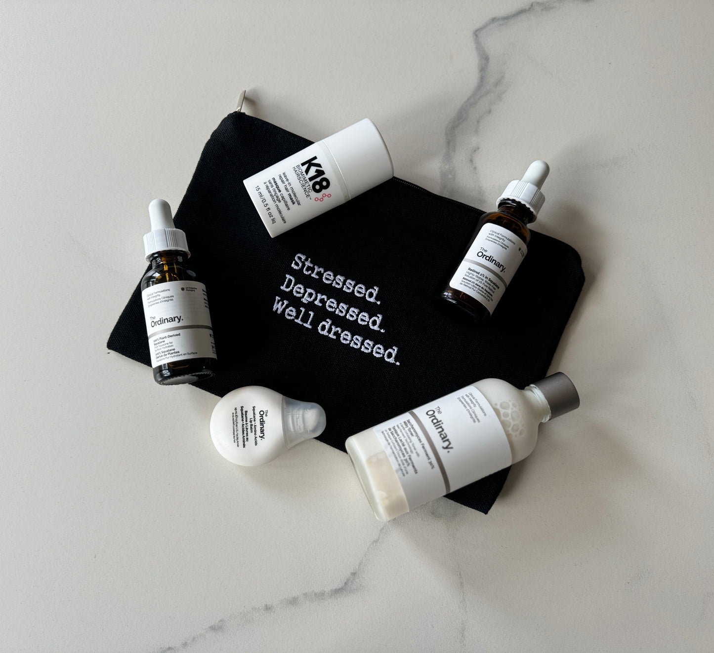 Stressed. Depressed. Well dressed. Cosmetics bag
